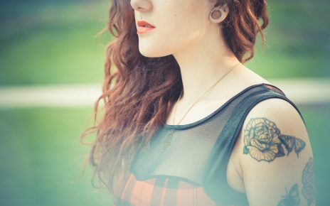 young beautiful hipster woman with red curly hair