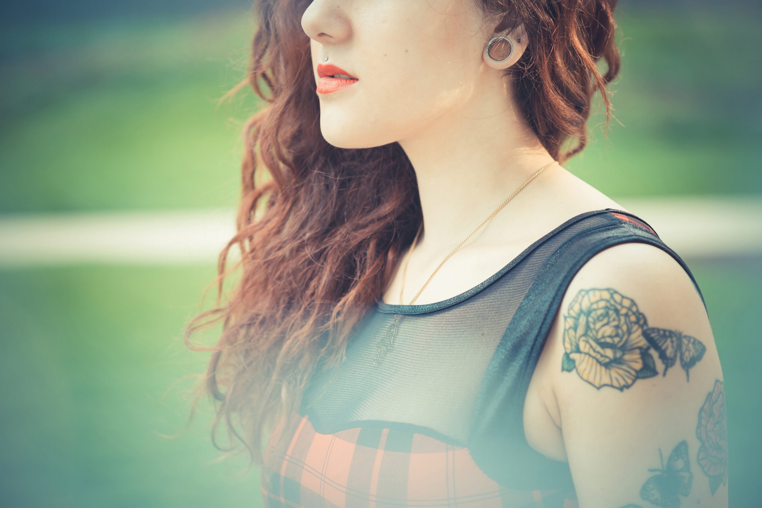 young beautiful hipster woman with red curly hair