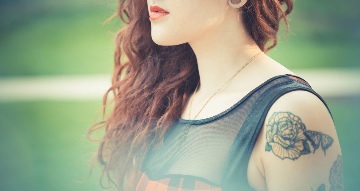 young beautiful hipster woman with red curly hair