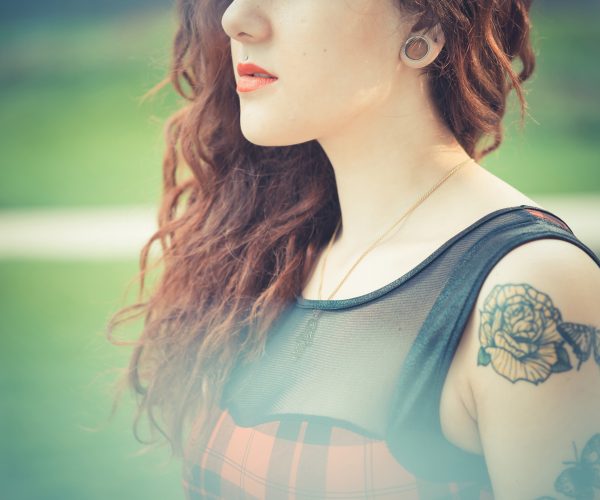 young beautiful hipster woman with red curly hair